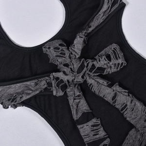 Close-up of distressed grey fabric bow detail on a black grunge style mini dress