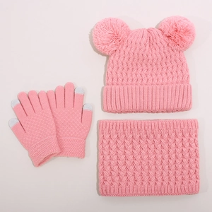Close-up of pink knitted winter set with dual-pompom hat, scarf, and touchscreen gloves