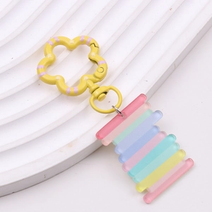 Detailed macro view of yellow flower metal clasp and rainbow gradient acrylic butterfly pendant
