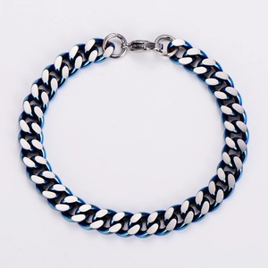 Macro detail of 9mm two-tone Cuban chain showing brushed and polished steel finishes