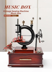 Close-up of vintage sewing machine music box with miniature iron and fabric details