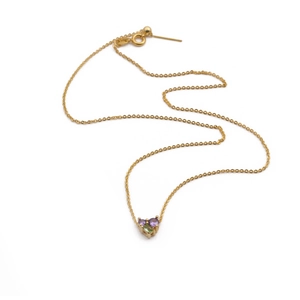 Collier cœur doré minimaliste avec pierres de zircon violettes et vertes sur fond blanc
