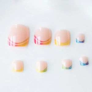Rainbow striped French press-on toenails with glossy finish on nude pink base