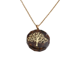 Golden chain necklace featuring a brown faceted crystal pendant with a tree of life charm