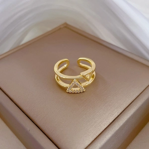 Detailed macro view of gold plated double-layer open ring with geometric zircon triangles