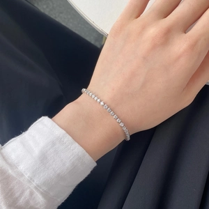 Close-up of elegant S925 silver tennis bracelet with pear-shaped stones on a wrist