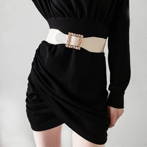 Chic beige elastic waist belt with sparkling rhinestone square buckle on a summer dress