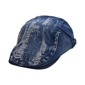 Frayed blue denim beret with distressed hole details and vintage wash for a retro style