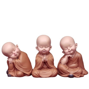 Three cute little monk figurines in sitting and sleeping poses for car dashboard decoration