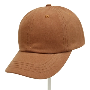 Detailed close-up of a brown cotton baseball cap showing the twill fabric texture and stitching