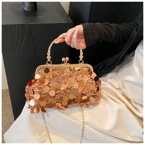 Detail of gold sequin handbag with chain strap and metallic handle for evening dress