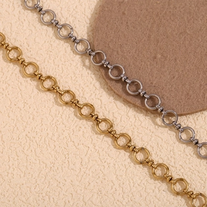 Detail view of 14K gold and silver stainless steel chain links with circular toggles