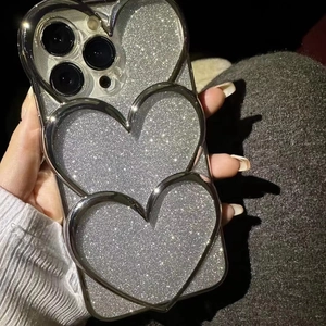 Detail of silver glitter phone case with three 3D metallic heart frames for iPhone