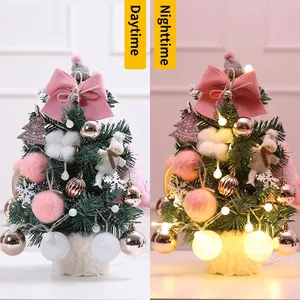 Mini tabletop Christmas tree with pink bows and LED lights in day and night views