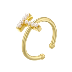 Detailed view of copper letter T ring with pearl inlay and elegant golden finish