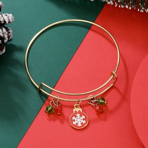 Detail of adjustable Christmas bracelet with snowflake charm and pine cone background