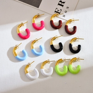 Detail view of U-shaped gold-plated earrings set with six colorful enamel finishes