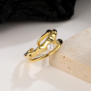 Detailed shot of golden irregular melted line ring featuring a white round pearl