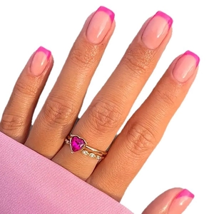 Pink heart-shaped gemstone ring set in rose gold finish on model with manicured hand