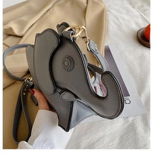 Detail of grey faux leather elephant bag featuring gold zippers and stitched ears