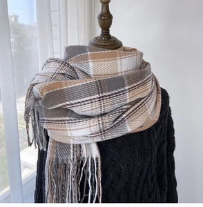 Detail of British style checkered scarf with tassels on a mannequin with black sweater