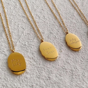 Detail of 18K gold stainless steel May June and July birth flower necklace pendants