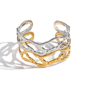 Minimalist geometric hollow open bangle in gold and silver bicolor with organic branch texture
