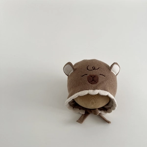 Detail of baby bear knit hat featuring 3D ears, brown embroidery and secure chin straps