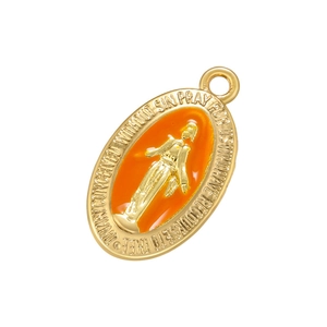 Detailed macro of gold Miraculous Medal pendant with vibrant orange enamel inlay