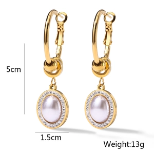 Detail view of gold hoop earrings with pearl pendant showing 5cm length and 13g weight