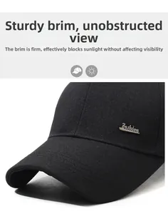 Detail view of black baseball cap with silver Fashion metal logo and twill fabric texture