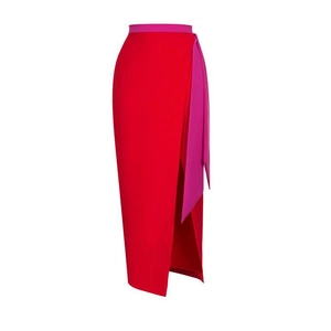 High-waisted red midi skirt featuring a side slit and magenta ribbon tie accent
