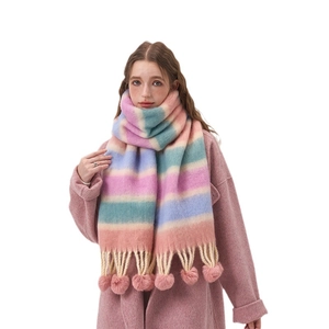Rainbow striped winter scarf with pompom trim and fringes on white background