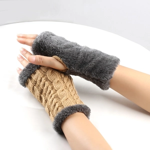 Detail of cable knit gloves with plush faux fur trim and cozy fingerless design