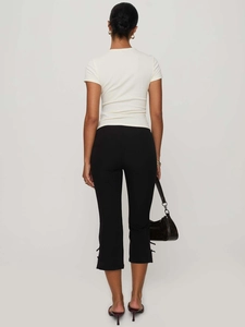 Women's black cropped flare trousers with bow detail and elastic waist back view