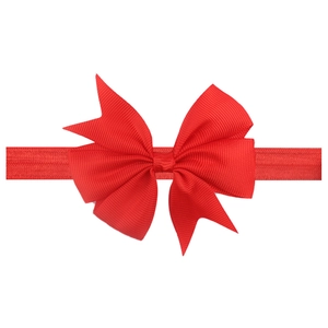 Detailed view of red grosgrain ribbon bow headband with high-quality ribbed texture