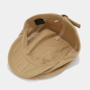 Detail of khaki cotton ivy cap interior showing wash label and adjustable strap