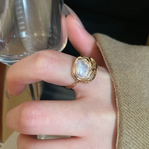 Macro shot of gold vintage organic ring featuring a large oval opal on a branch band