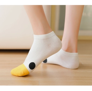 Close-up of white ankle socks with a cute yellow duck face design on the toes