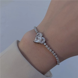 Macro shot of a silver star bracelet with a sparkling heart-shaped zirconia centerpiece