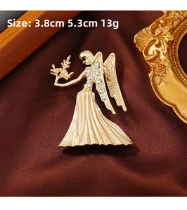 Detail of golden angel fairy brooch with rhinestones, size 3.8cm by 5.3cm, matte finish