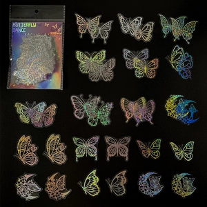 Flat lay of 100pcs holographic butterfly stickers with floral and moon motifs