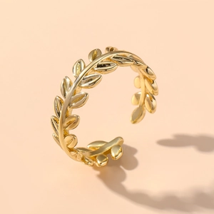 Close-up of golden laurel leaf adjustable ring with a polished metallic finish