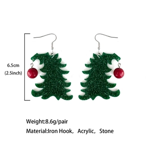 Green acrylic Christmas tree earrings with stone accents, 6.5cm length on studio background