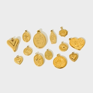 Detail view of 12 gold-plated stainless steel pendants including hearts and crosses