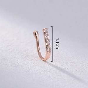 Macro detail of rose gold U-shaped nose ring with sparkling crystals, sized 1.1cm