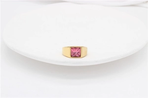 Close-up of minimalist gold titanium steel ring featuring a square pink gemstone inlay