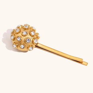 Detail of 18K gold plated hair clip with a sphere encrusted in clear sparkling rhinestones