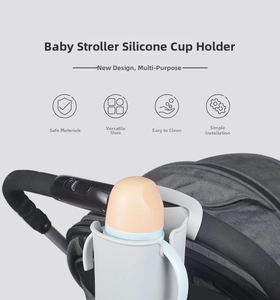 Light gray silicone cup holder attached to a stroller handle with an orange baby bottle