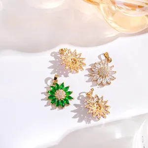 Detail of gold-plated sunflower pendants with green and white marquise zircon stones